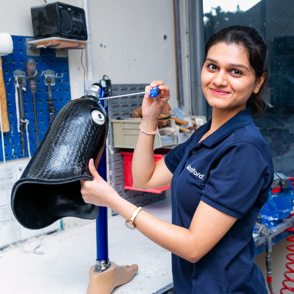 Member of staff working on a prosthetic limb